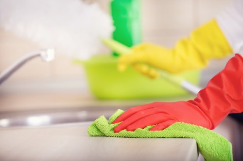 Cleaner wearing PPE during carpet cleaning work